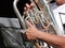 Close up of a silver tuba being played