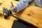 Close-up simple wooden worktable with camera, tablet computer