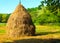 Close-up of a single big haystack near forest