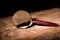 Close up Single Magnifying Glass with Black Handle, Leaning on the Wooden Table at the Office.