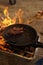 Close-up of a sizzling barbecue with sausages grilling over an open flame