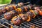 close-up of sizzling sausage links on a backyard grill