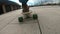 Close-up skateboarder boy riding outdoor. A young guy rides a longboard in the park. Wearing traveler boots. Urban