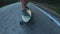 Close-up skateboarder boy riding outdoor. A young man rides a longboard on the highway. Misty road in the forest