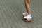 Close up of a skateboarders feet while skating on concrete at the skate park