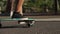 Close-up of a skater`s foot on the Board. Longboard rides on the road in slow motion