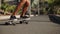 Close-up of a skater`s foot on the Board. Longboard rides on the road in slow motion