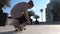 Close up of skater skateboarder man doing 360 kickflip heelflip flip trick in slow motion jump