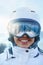 Close up of the ski goggles of a woman with the reflection of snowed mountains. Woman on the background, blue sky.