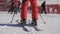 Close-up of a skier standing on skis in ski boots at a ski resort.