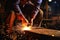 Close-up of skilled worker welding metal parts with sparks flying in detailed focus