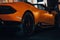 Close-up of a sleek, orange Lamborghini parked outside