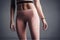 Close-up of a slender athletic woman\\\'s belly. A girl in sports leggings. Generative AI