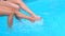 Close-up of slender legs two girls in the pool.