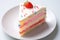 close-up of a slice of birthday cake on a white plate