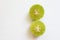 Close-up of a slice of green lemon   on a white background