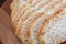Close-up of sliced bread. Rustic looking on wooden board background.