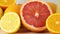 Close up of sliced lemon, grapefruit and orange next to lemonade