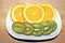 Close up of Sliced Oranges and Kiwi in a White Dish