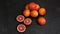 Close-up of a sliced ripe juicy Sicilian Blood oranges on black background.