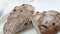 Close-up of sliced rye raisin bread on the white cutting board.