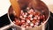 A close-up of sliced sausages from a bowl.