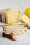 Close up of slices of glazed lemon pound cake loaf with poppy seedseed