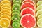 Close up of slices of oranges, lemons, kiwi, grapefruit pattern  on wooden background