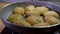 Close-up sliding view of frying fresh delicious meatballs on a hot pan