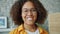 Close-up slow motion portrait of cheerful young woman with curly hair smiling