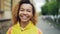 Close-up slow motion portrait of good-looking African American woman looking at camera with glad smile and laughing