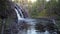 Close-up and slow motion shot of the breathtaking Hepokongas waterfall in Kainuu region, Finland. Water flowing from the rock at s