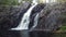 Close-up and slow motion shot of the breathtaking Hepokongas waterfall in Kainuu region, Finland. Water flowing from the rock at s