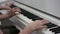 A close up slow motion showcase of hands of an adult and a child who are composing a tune on the piano at the same time