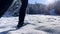 Close up slow motion woman in snow boots walking through fresh snow