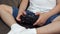 Close-up of a small child playing video games at home, he holds a joystick.