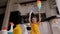 Close-up of a small girl playing in the kitchen with detergents and brushes.