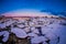 Close up of small and medium pieces of Ice on a frozen lake