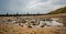 Close up of small rock pool on a sandy beach on the Norfolk coastline