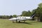 Close up of a small two-engine plane parked on a grass field