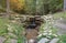 Close up of a small waterfall spilling over moss covered rocks in regional park. Handmade river waterfall