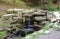 Close up of a small waterfall spilling over moss covered rocks in regional park. Handmade river waterfall