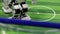 Close up of smart humanoid robot foot warming up on football field