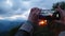 Close-up smartphone in the hands of a woman takes a video of the sunset. Beautiful red sunset video of a hiker on a