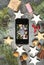 Close-up of smartphone with picture of Christmas decoration on b