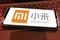 Close-up of smartphone screen with logo lettering of chinese xiaomi mobile phone company .