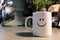 Close up Smiley happy coffee cup mug on metal table