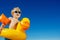 Close-up of a smiling blond boy with inflatable yellow duck buoy