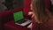 Close up smiling businesswoman lying on sofa and working laptop green screen chromakey at home. Girl hands typing on