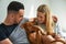 Close-up of smiling couple holding Hungarian Vizsla